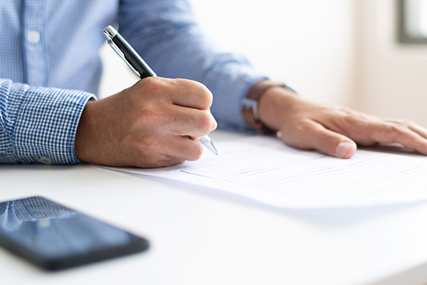Man signing a document.