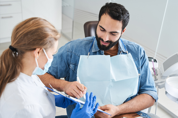 Dental patient speaking with a dentist.